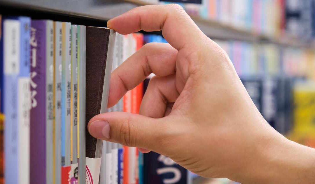 meno cogiendo un cómic de manga japonés en una librería